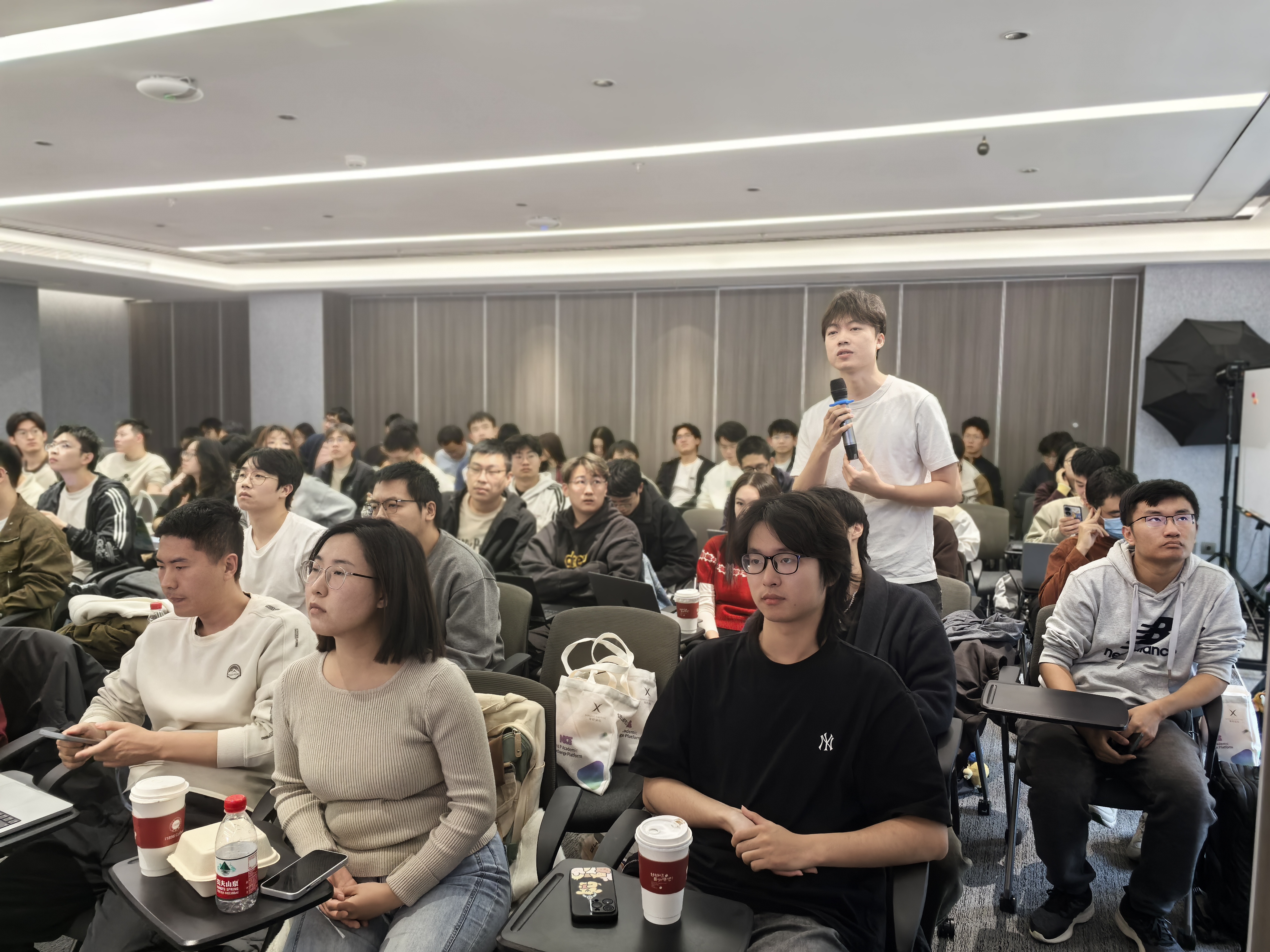 Packed audience asking questions